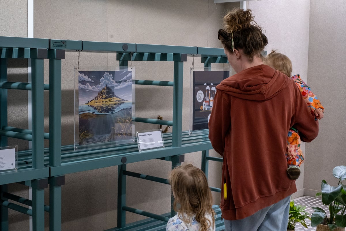 mother and two children looking at art