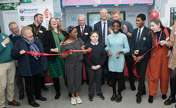 Children and university staff cutting the ribbon to open the IntoUniversity centre in Walker