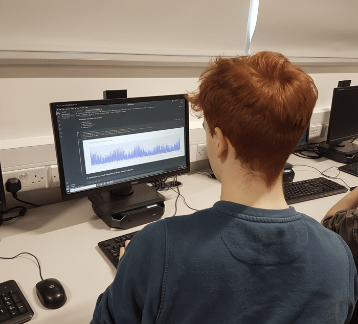 a student looking at a computer screen with a data visualisation on it